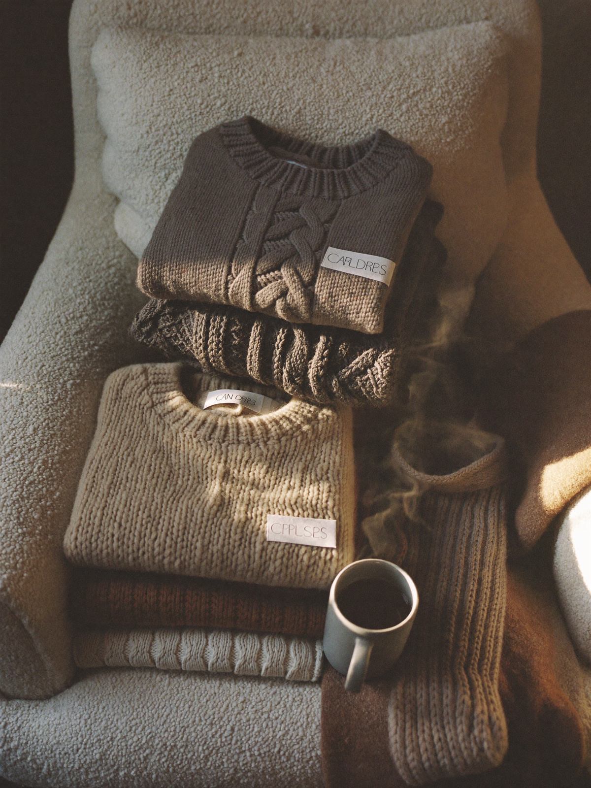 Chunky knit homewear and socks on a boucle armchair